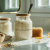 Jars of natural goat milk body scrub with fresh ingredients